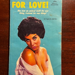 May include: Vintage paperback book titled "HUNGRY FOR LOVE!" with a teal background and a woman's portrait. The cover includes text: "She was an animal built for one thing, trained for one thing!" and "ADULT READING."