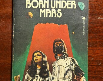 May include: Vintage paperback book cover for "Born Under Mars" by John Brunner. The cover features a retro sci-fi illustration with two figures in futuristic attire against a backdrop of Mars-like terrain. The title and author's name are prominently displayed.