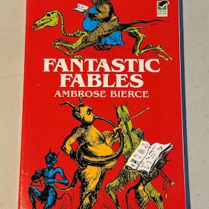 May include: A red book cover with the title "Fantastic Fables" by Ambrose Bierce. The cover features an illustration of a group of cartoonish, devil-like figures playing musical instruments. The book is part of the Dover Thrift Editions series.