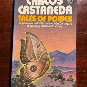 May include: A paperback book cover with a brown and white butterfly on a desert landscape background. The book title is "Tales of Power" by Carlos Castaneda.
