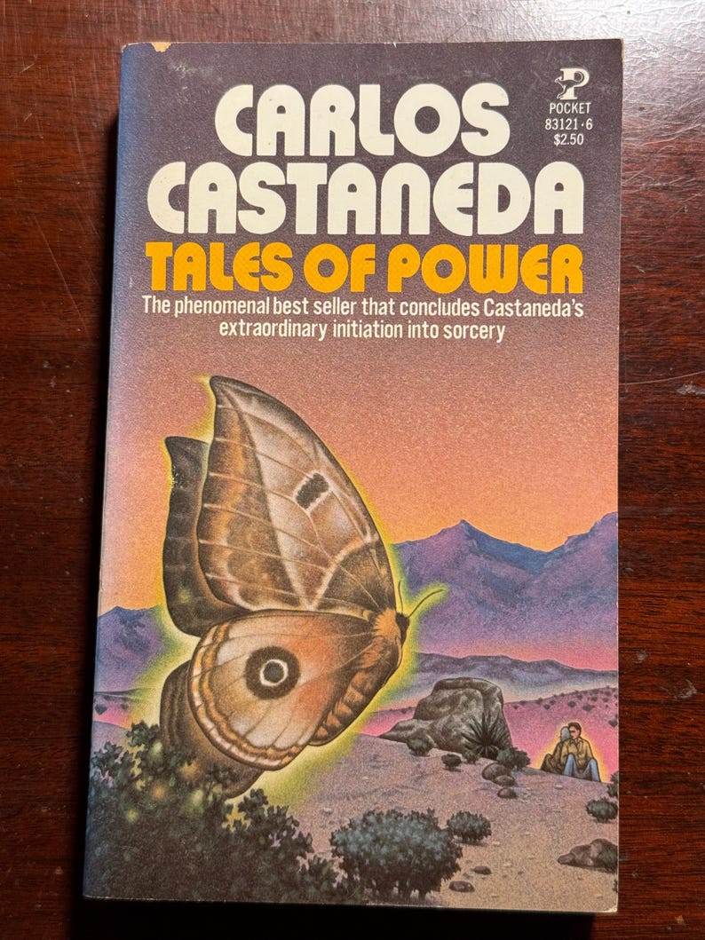 May include: A paperback book cover with a brown and white butterfly on a desert landscape background. The book title is "Tales of Power" by Carlos Castaneda.