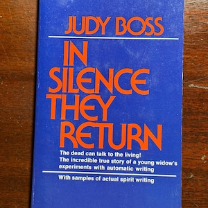 May include: A vintage paperback book titled "IN SILENCE THEY RETURN" by Judy Boss. The cover is blue with orange lettering. The text includes "The dead can talk to the living!" and "With samples of actual spirit writing."