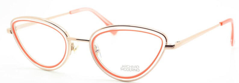 May include: Cat-eye shaped eyeglasses with a gold metal frame and a bright orange accent around the lenses. The brand name "Archivio Moderno" is printed on the right lens.