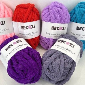 May include: Six balls of yarn in various colors, including pink, red, purple, lavender, teal, and gray. Each ball has a white label with the text "BECOZI Stay warm and BeCozi!"