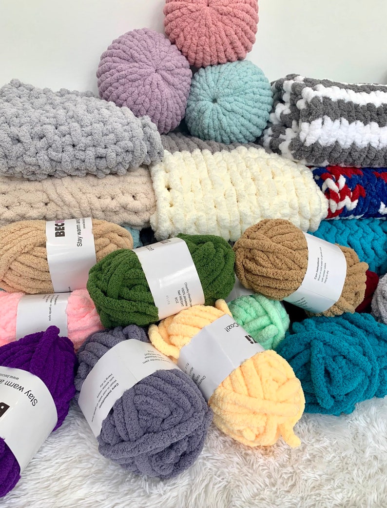May include: A variety of colorful yarn balls in different shades of pink, purple, green, brown, blue, and gray. The yarn is soft and fluffy, and it is perfect for crocheting or knitting. The yarn is labeled with the words "Stay Warm" and "Cozy".