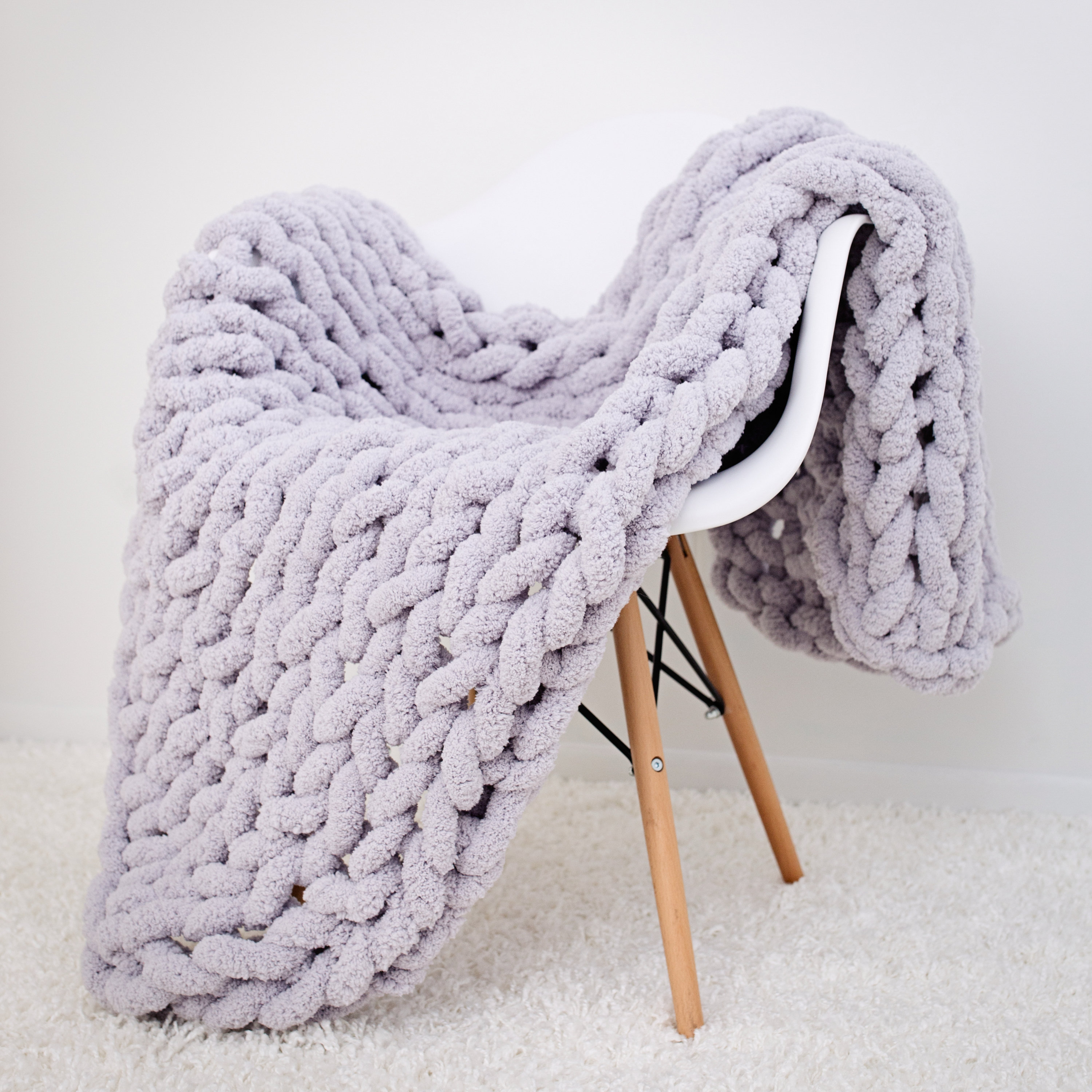 Knitted and Folded Chunky Blanket with Knitting Needles, Yarn Ball in Human  Hands on Neutral Background Stock Image - Image of craftsmanship, craft:  208859619