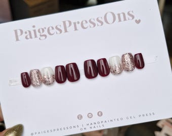 May include: Burgundy and white press-on nails with glitter accents.  The nails are short and square shaped.  The text "PaigesPressOns" is visible in the image.