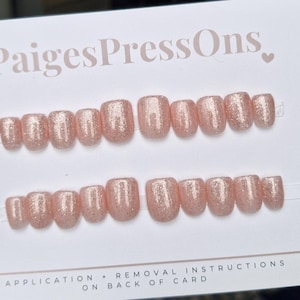May include: Two rows of ten pink glitter press-on nails. Application and removal instructions are on the back of the card. PaigesPressOns.