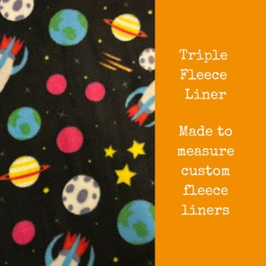 May include: A black fleece fabric with a space-themed print featuring planets, rockets, and stars. The text "Triple Fleece Liner Made to measure custom fleece liners" is printed on a bright orange background.
