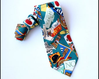 May include: A teal blue necktie with a pattern of various colorful labels and logos, including "Vichy", "Royale", "Saddler", and "No".