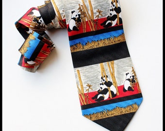 May include: A black and white silk tie with a pattern of pandas eating bamboo. The tie has red, blue, and gold accents.