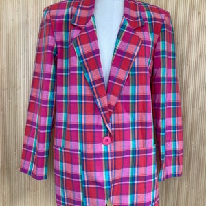 May include: A pink, red, green, and blue plaid blazer with a single button closure.