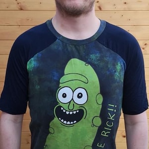 May include: A black and green t-shirt with a pickle character graphic and the text "...I'M PICKLE RICK!!".