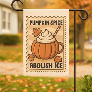 May include: A rectangular garden flag featuring a postage stamp design with a tan background. The graphic shows an orange pumpkin-shaped mug filled with whipped cream and a striped straw, surrounded by maple leaves. Text reads PUMPKIN SPICE ABOLISH ICE.