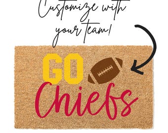 May include: A rectangular doormat with the words "GO Chiefs" in yellow and red, and a brown football graphic. The mat is made of a natural fiber material and has the text "Customize with your team!" in black script.