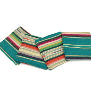May include: Four colorful striped fabric coasters in shades of teal, pink, orange, and white. The coasters are made of a soft, woven fabric and are perfect for protecting surfaces from scratches and spills.