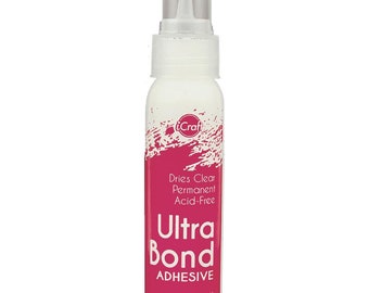 May include: A white bottle of iCraft Ultra Bond adhesive with a clear nozzle. The label features a pink splash design and text that reads "Dries Clear Permanent Acid-Free." The bottle contains 2 fl oz.