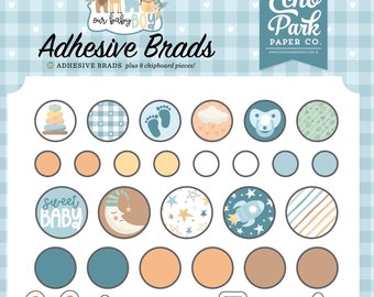 May include: A set of baby boy themed adhesive brads with various designs including a bunny, a rocket, a rainbow, a star, a cloud, a pacifier, a moon, a stack of rings, a pair of socks, and a banner that says "bundle of joy". The brads are on a blue and white checkered background.