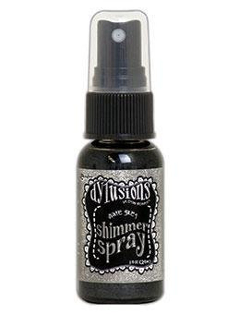 May include: A small bottle of black shimmer spray with a silver label that reads "d'vine shimmer spray".