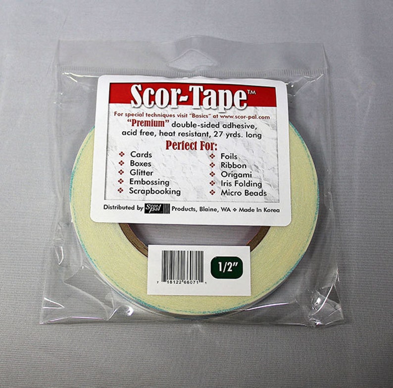 May include: A roll of Scor-Tape Premium double-sided adhesive tape in a clear plastic bag. The tape is 1/2 inch wide and is acid free, heat resistant, and 27 yards long. The tape is perfect for cards, boxes, glitter, embossing, scrapbooking, foils, ribbon, origami, iris folding, and micro beads.