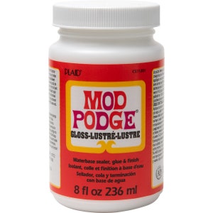 May include: A white plastic bottle of Mod Podge Gloss-Lustre waterbase sealer, glue & finish. The label is red with the product name in large, pink and orange letters. The bottle contains 8 fl oz (236 ml).