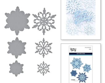 May include: A set of five snowflake-shaped metal cutting dies. The dies are in various sizes and feature intricate designs. The dies are packaged in a clear plastic sleeve with a white label that reads "Snow Flurries Cutting Dies".