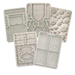 May include: Five silicone molds for baking and decorating cakes and other desserts. The molds feature intricate designs, including a window, a gate, a floral pattern, playing cards, and frames.