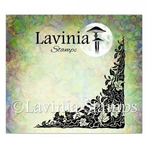 May include: A square image with a watercolor background in shades of green, yellow, and blue. The image features the text "Lavinia Stamps" and a black and white illustration of mushrooms in front of a moon. A black floral design is in the corner.