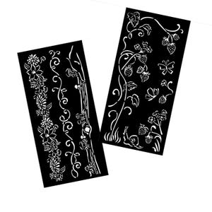 May include: Two black stencils with white floral and vine designs. One stencil features strawberries and butterflies. The other stencil features a repeating floral pattern.