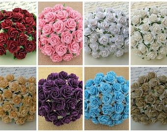 May include: Assortment of 25 small paper roses in various colors, including burgundy, pink, white, ivory, beige, purple, light blue, and brown. The roses are arranged in a circular pattern.