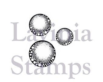 Può includere: Tre timbri circolari in bianco e nero con un design a bolle. Il testo "Lavioia Stamps" è sullo sfondo.