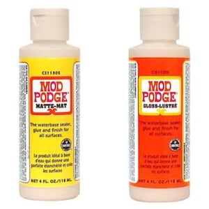 May include: Two bottles of Mod Podge decoupage glue and sealer. One bottle is labeled "Matte-Mat" and the other is labeled "Gloss-Lustre". Both bottles are 4 fluid ounces.