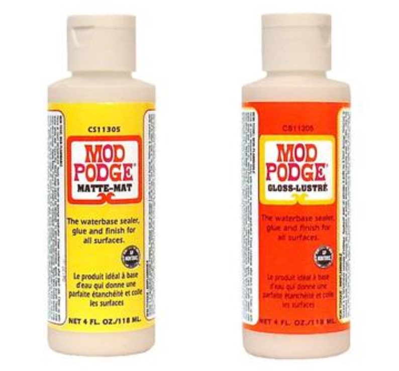 May include: Two bottles of Mod Podge decoupage glue and sealer. One bottle is labeled "Matte-Mat" and the other is labeled "Gloss-Lustre". Both bottles are 4 fluid ounces.