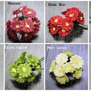 May include: Assortment of 10 bunches of paper flowers in various colors, including burgundy, maroon, dark red, red, green, olive green, mint green, and seafoam. Each bunch contains approximately 10 flowers.