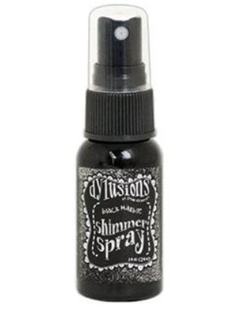 May include: A black bottle of Dylusions Shimmer Spray in Black Magic. The bottle has a black and white label with the text "Dylusions Black Magic Shimmer Spray" on it.