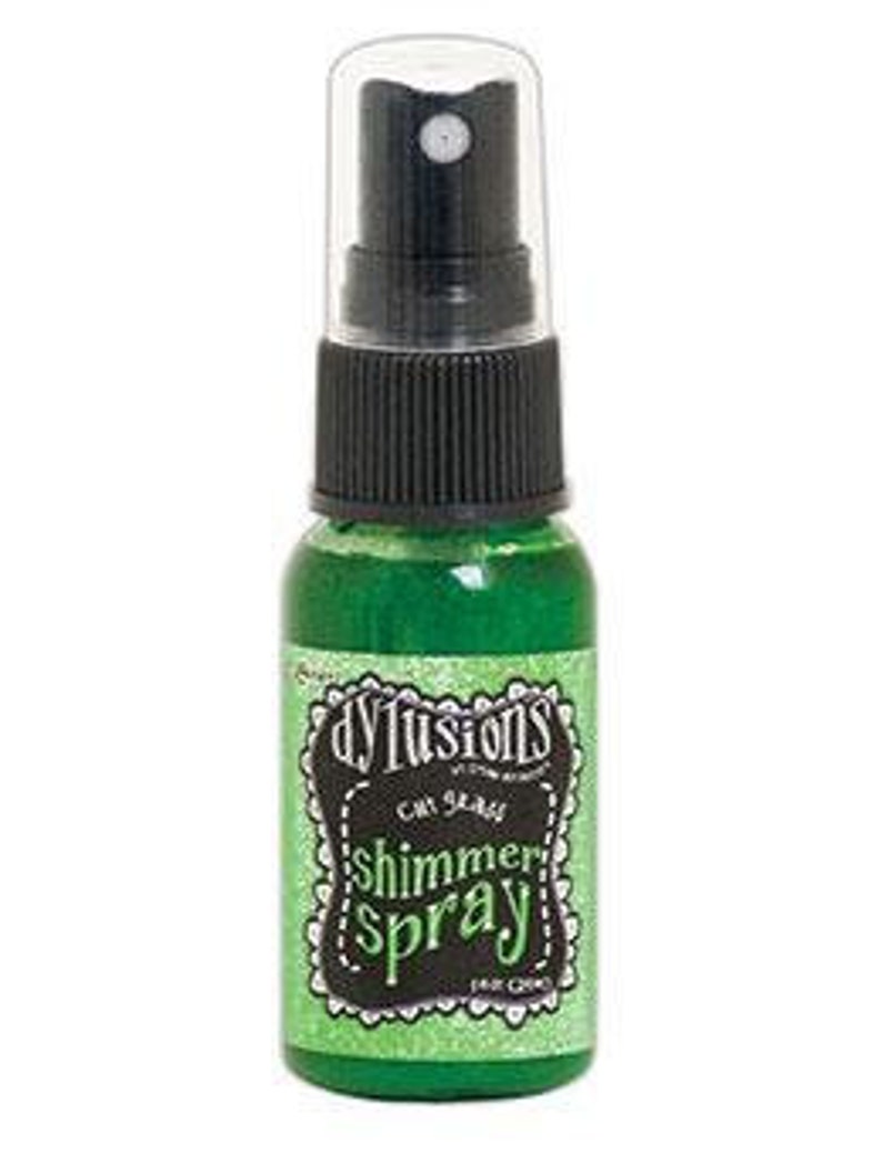 May include: A small green bottle of Dyalusions Shimmer Spray with a black spray nozzle. The bottle has a white label with black text that reads "Dyalusions Shimmer Spray" and "Sea Green".