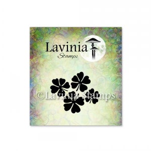 May include: A black and white image of four four-leaf clovers on a green and white background. The text "Lavinia Stamps" is at the top of the image.