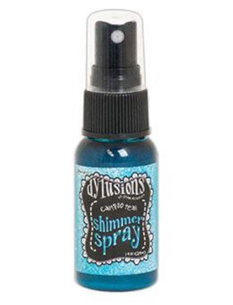 May include: A small bottle of turquoise blue shimmer spray with a black cap and label that reads "Dylushions  Craft  Shimmer Spray  Aqua Chino"