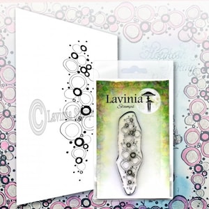 May include: A clear rubber stamp with a design of overlapping circles in a vertical arrangement. The stamp is labeled "Lavinia Stamps" and is packaged in a clear plastic sleeve.