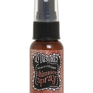 May include: A small bottle of Dylusions Shimmer Spray in the colour "Copper". The bottle is clear with a black spray nozzle and a black label with white text.