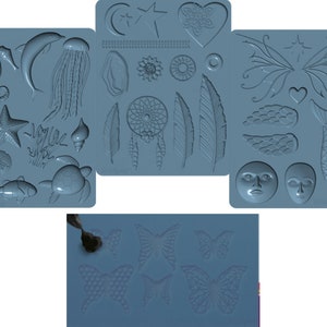 May include: Four blue silicone molds for making various shapes, including sea creatures, feathers, butterflies, and a dreamcatcher. The molds are on a white surface.