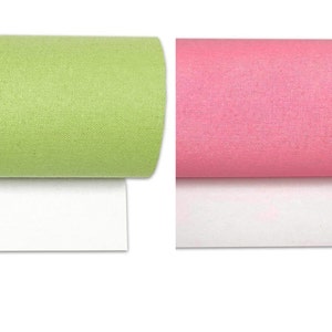 May include: Two rolls of fabric, one green and one pink, are shown on a white background. The fabric has a subtle texture.