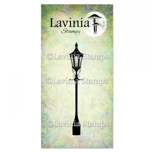 May include: Black and white silhouette of a street lamp with a round top and a decorative design. The lamp is on a green and white background with the text "Lavinia Stamps" in black.
