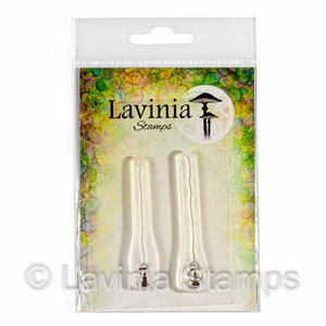 May include: A clear plastic package containing two clear rubber stamps with images of hanging lanterns. The package has a white background with a colorful design and the text "Lavinia Stamps" in black.