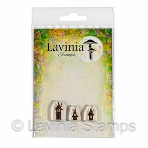 May include: Clear plastic package containing Lavinia Stamps. The package features three brown house-shaped stamps and a mushroom illustration. The Lavinia Stamps logo is visible in the upper left corner and at the bottom of the package.