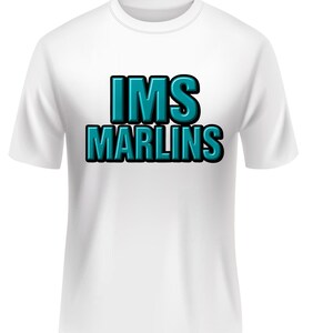 May include: White t-shirt with the text "IMS MARLINS" in teal and black 3D lettering. The shirt has short sleeves and a crew neck. The text is centered on the front of the shirt.