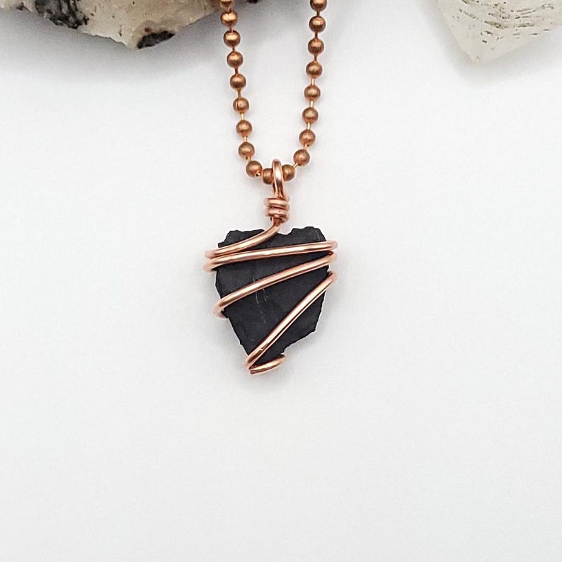 May include: A copper chain necklace with a shungite stone wrapped in copper wire.