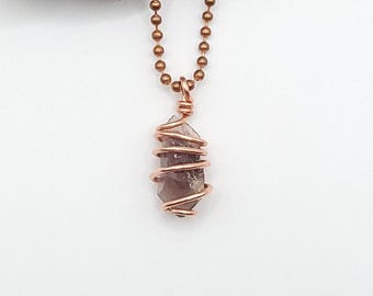 May include: A copper chain necklace with a copper wire wrapped amethyst crystal pendant.