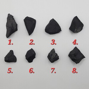 6 raw shungite crystals numbered 1 through 8