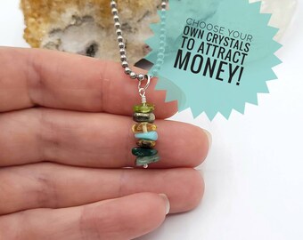 May include: A silver chain necklace with a pendant made of stacked, multi-colored gemstones. The pendant is held in a hand. The text "Choose your own crystals to attract money!" is in a speech bubble.